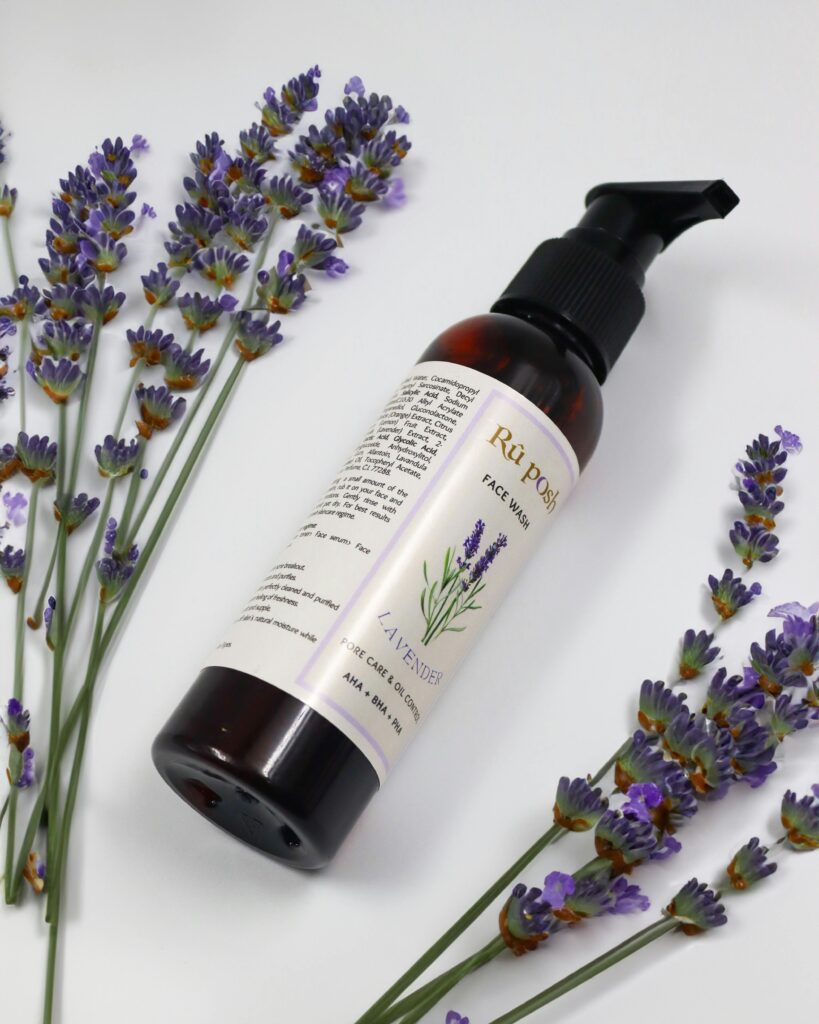 Lavender face wash surrounded by fresh lavender flowers for a calming skincare routine.